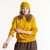 Model wearing organic cotton fisherman beanie in color gold