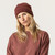 Model wearing organic cotton fisherman beanie in color masala