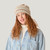 Close up of model wearing organic cotton chunky beanie in color pearl stripe