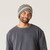 Close up of model wearing organic cotton chunky beanie in color heather grey stripe.