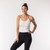 Front view of model wearing organic cotton camisole in color natural