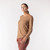 Side view of model wearing organic cotton layering tee in color turmeric