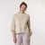 Close up front view of model wearing organic cotton 3/4 sleeve tee in color pearl.