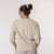 Close up back view of model wearing organic cotton 3/4 sleeve tee in color pearl.