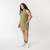 Side view of model wearing organic cotton hi low dress in color bay.
