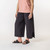 Close up view of model wearing organic cotton gaucho pant in color pepper.