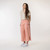 Full body view of model wearing organic cotton gaucho pant in color blush.