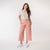 Full body view of model wearing organic cotton gaucho pant in color blush.