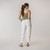 Full body back view of model wearing organic cotton harem pant in color salt.