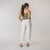 Full body back view of model wearing organic cotton harem pant in color salt.