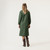 Full body back view of model wearing organic cotton workwear dress in color pine.