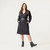 Full body front view of model wearing organic cotton workwear dress with a belt around the waist in color pepper.