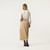 Back view of model wearing 100% organic cotton surplus skirt in color khaki.