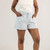 Close up front view of model wearing 100% organic cotton camp shorts in color light blue.