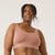 Front view of model wearing organic cotton scoop bralette in color clay.