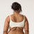 Back view of model wearing organic cotton ruched bralette in color natural.