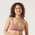 Front view of model wearing organic cotton ruched bralette in color clay.