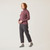 Full body side view of model wearing organic cotton turtleneck in color plum.