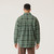 Back view of model wearing 100% Regenerative Organic Certified Cotton Plaid Workwear Shirt in pine.