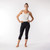 Model wearing organic cotton base layer leggings midcalf in solid black.
