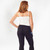 Model wearing black solid color organic cotton mid calf blackout leggings shown from the back.