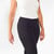 Model wearing black solid color organic cotton mid calf blackout leggings shown closeup.