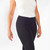 Model wearing black solid color organic cotton mid calf blackout leggings shown closeup.