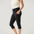 Model wearing black solid color organic cotton mid calf blackout leggings shown closeup from the side.