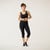Model wearing black solid color organic cotton mid calf blackout leggings shown from the front.