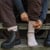 Lifestyle photo of organic wool mountain hiker socks in raspberry.