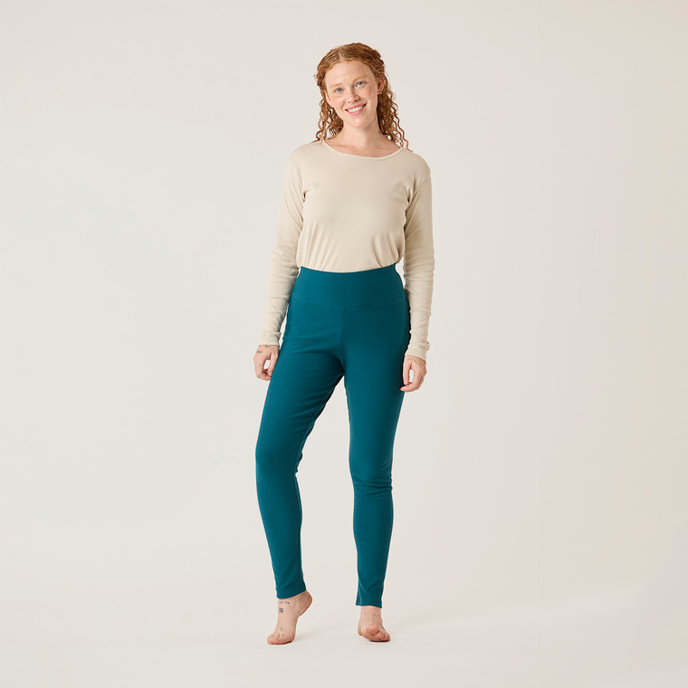 Full body front view of model wearing teal color organic cotton fleece leggings.