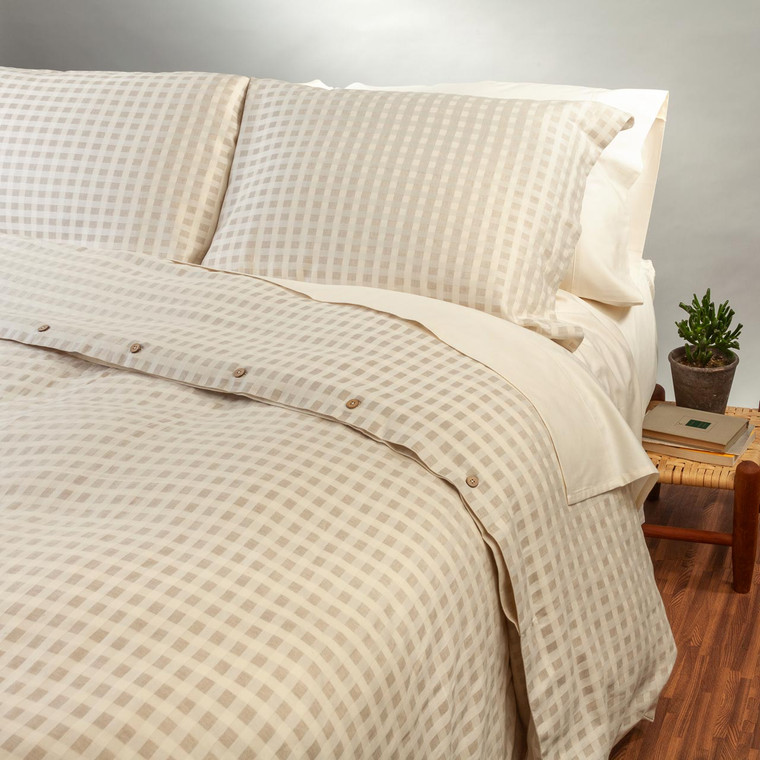 Natural checkered organic cotton and linen Pillow Sham Set shown on a bed.