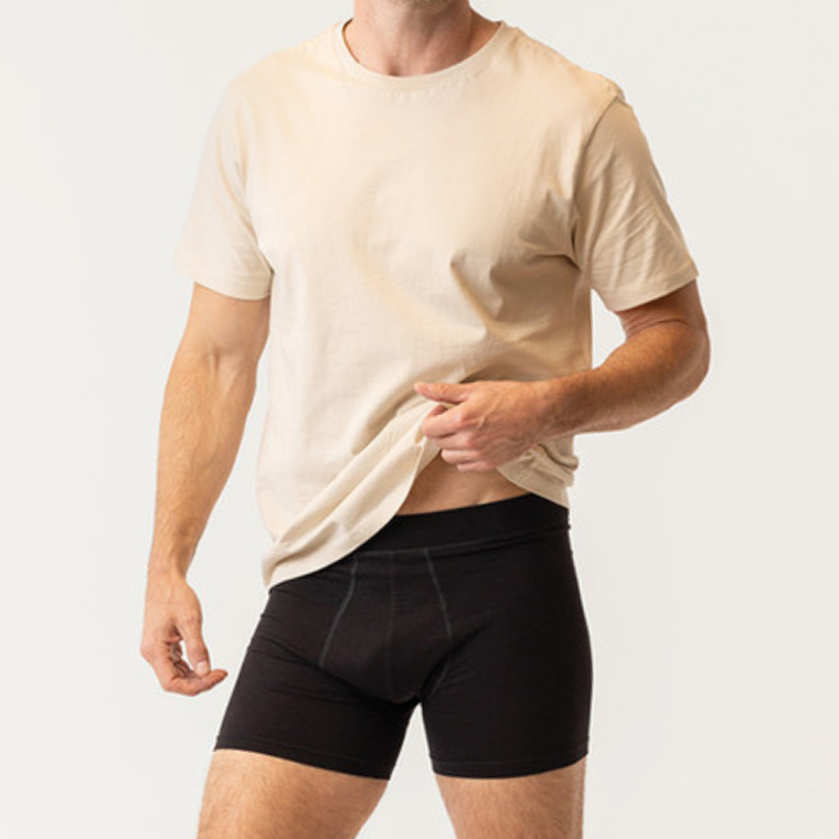 Close up front view of model wearing organic cotton essentials men's boxer briefs 2 pak in color black