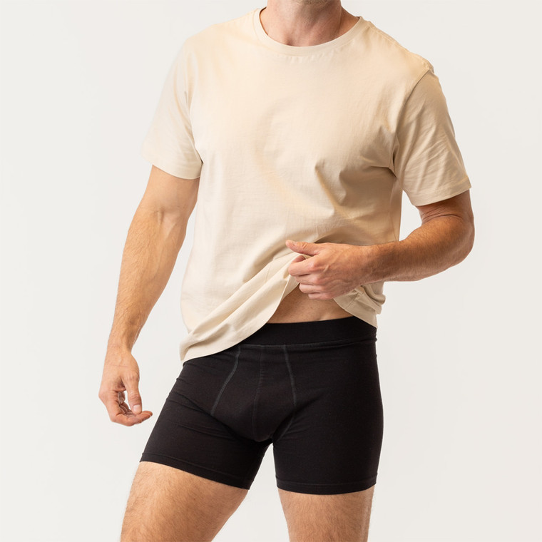 Close up front view of model wearing organic cotton essentials men's boxer brief 2 pak in color black