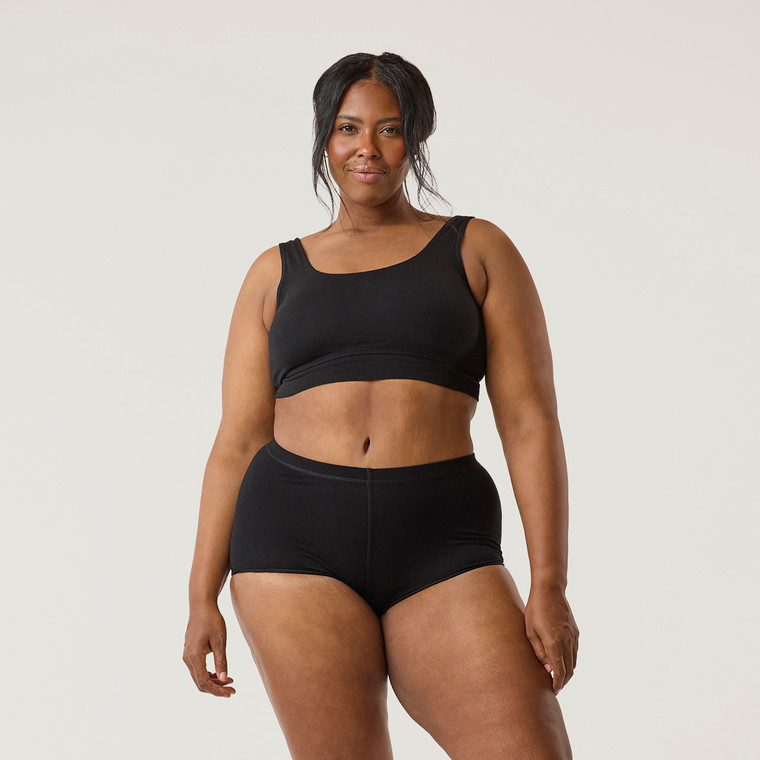 Front close up view of model wearing organic cotton essentials women's boyshort 2 pack in color black.