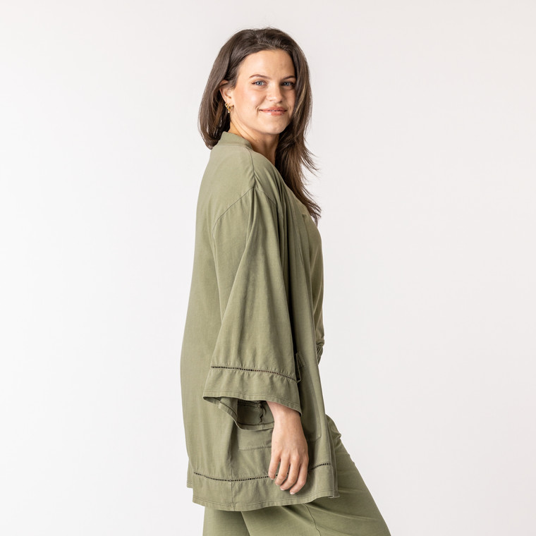 Side view of model wearing organic cotton kimono in bay.