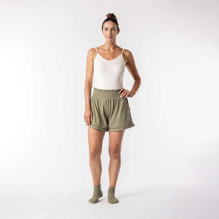 Full body front view of model wearing lounge short in bay.