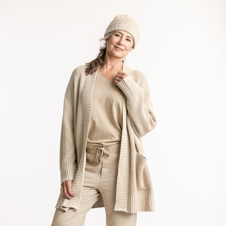 Front view of model wearing organic cotton cardigan sweater in color pearl