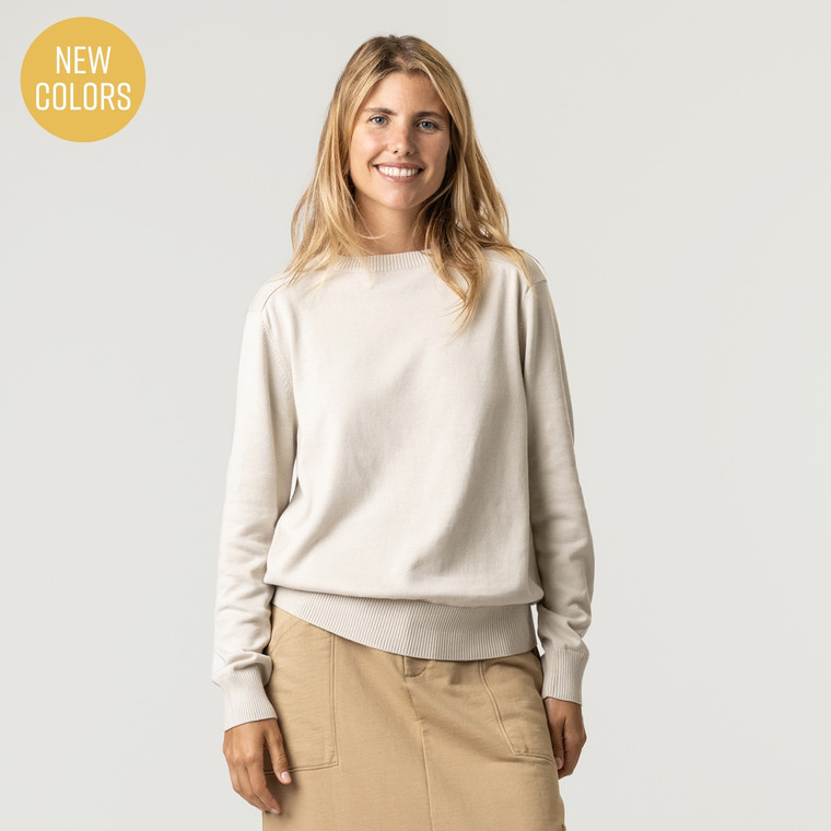 Front view of model wearing organic cotton classic crew sweater in color pearl.