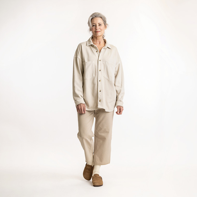 Full body front view of model wearing organic cotton workwear shirt in color pearl.