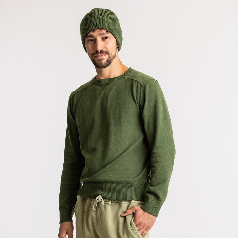 Model wearing organic cotton fisherman beanie in color pine