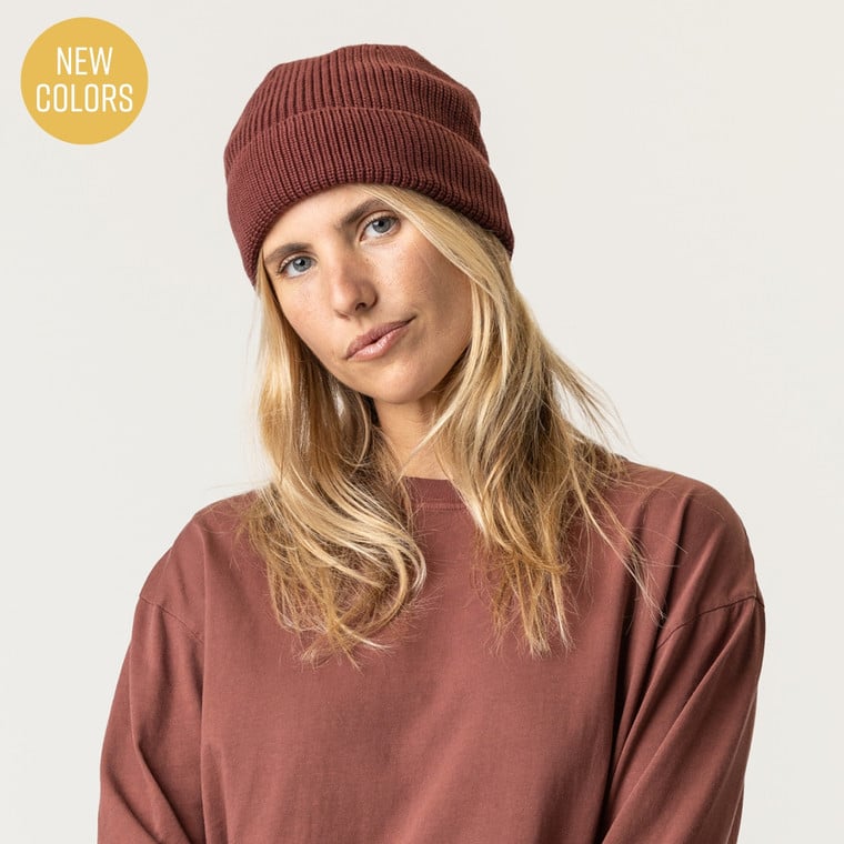 Model wearing organic cotton fisherman beanie in color masala
