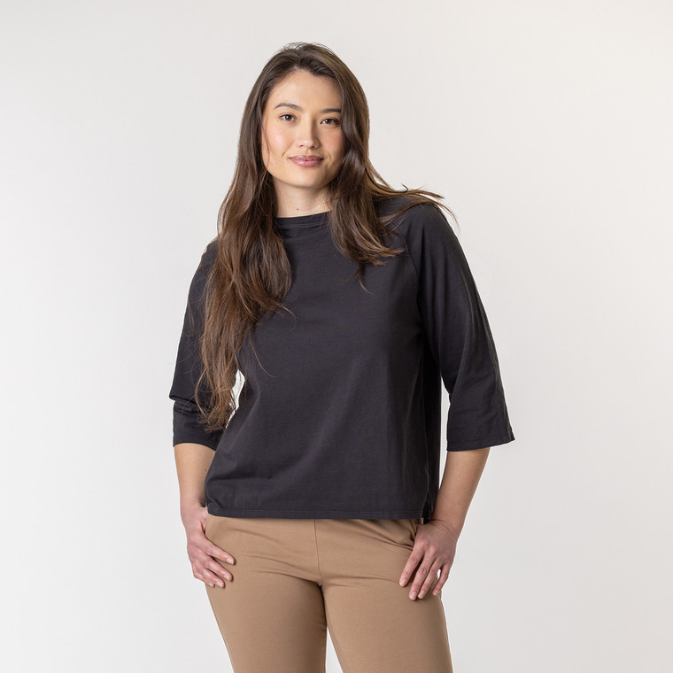 Close up front view of model wearing organic cotton 3/4 sleeve tee in color pepper.