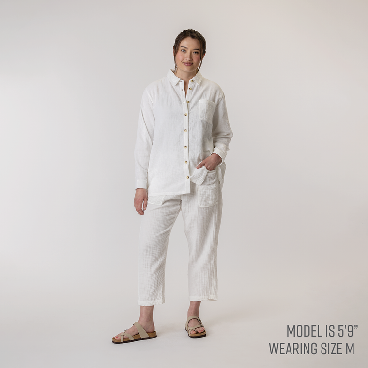 Full body front view of model wearing organic cotton button down shirt in color salt.