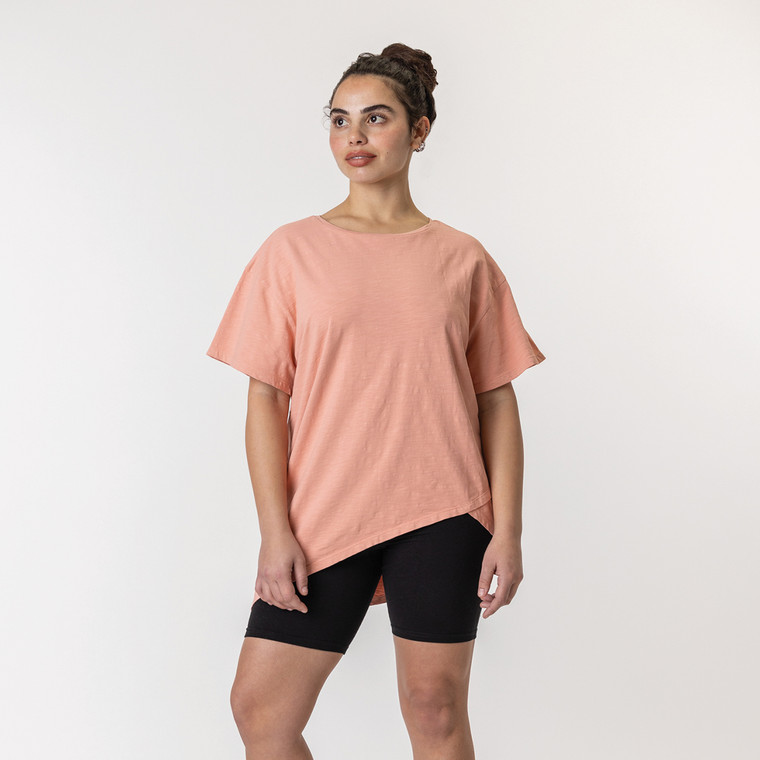 Full body front view of model wearing organic cotton French tuck tee in color blush.