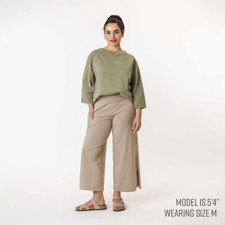 Full body view of model wearing organic cotton gaucho pant in color putty.