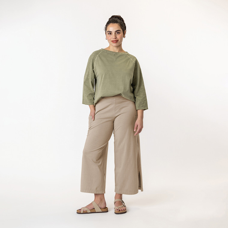 Full body view of model wearing organic cotton gaucho pant in color putty.