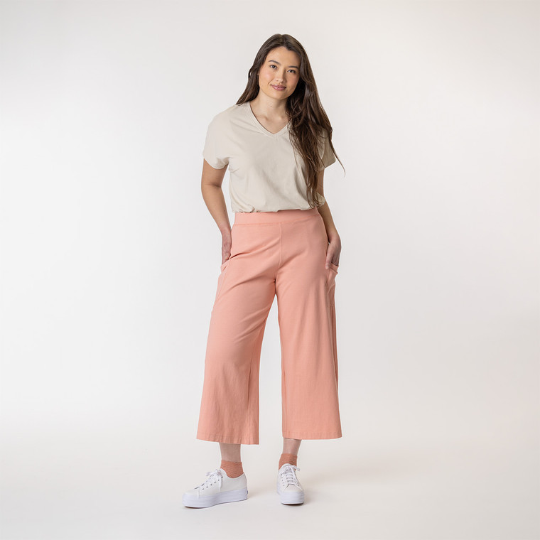 Full body view of model wearing organic cotton gaucho pant in color blush.