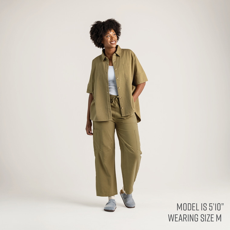 Full body front view of model wearing 100% organic cotton camp shirt in color bay.