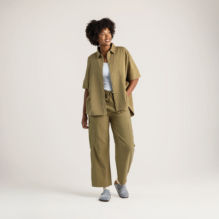 Full body front view of model wearing 100% organic cotton camp shirt in color bay.